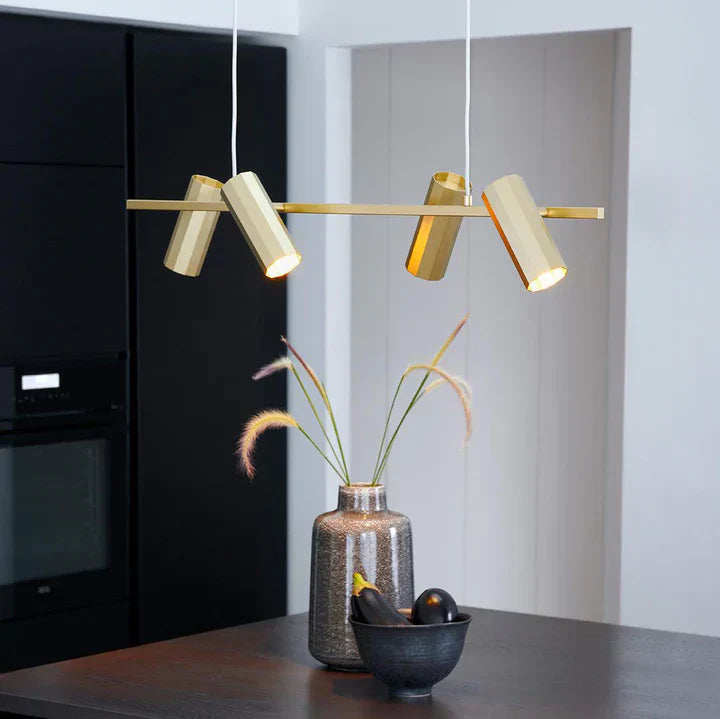 Golden pendant light above kitchen counter with a vase